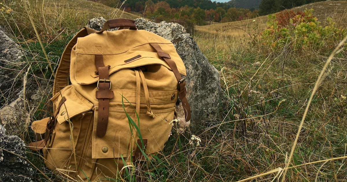 Backpack in an autumn mountain landscape, illustrating fall-hike preparation