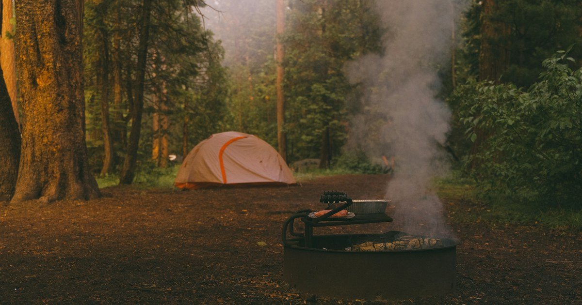 Campfire near a tent illustrating responsible fire choices